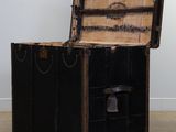 an old trunk sitting in the middle of a room