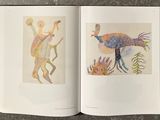 a book opened to show a picture of a man and a bird