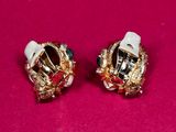 pair of gold tone earrings with green and white stones