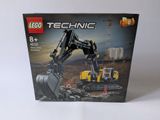 a box of lego technic construction equipment sitting on a white surface