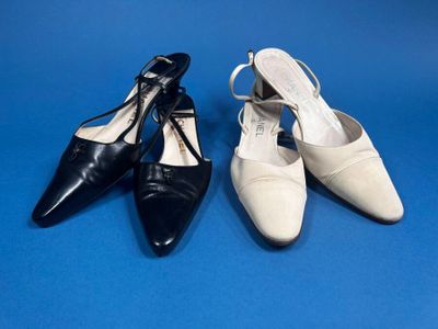 two pairs of black and white shoes on a blue background