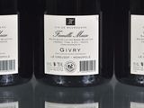 three bottles of wine sitting on top of a table next to each other