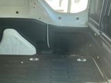 a white van with the door open and the floor in the back