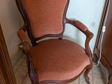 a chair that is sitting next to a cabinet