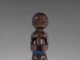 a wooden figure of a man with a bowl in his hands