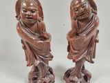 pair of chinese carved wood figurines of a man and a woman