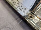 a close up of a mirror with a flower on it