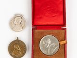an image of a silver medal and a silver coin in a red case