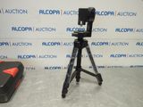 an image of a tripod sitting on top of a table next to a suitcase