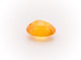 a yellow sapphire stone on a white background