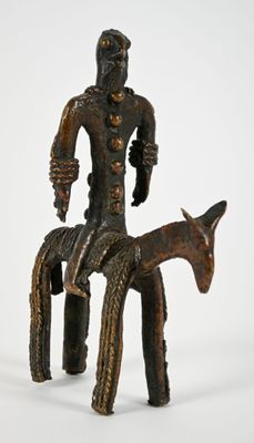 statue of a man sitting on a horse with a goat in front of him