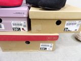 three boxes of shoes are stacked on top of each other