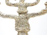 a silver candelab with a bird on top of it