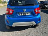 a blue car that is parked in a parking lot
