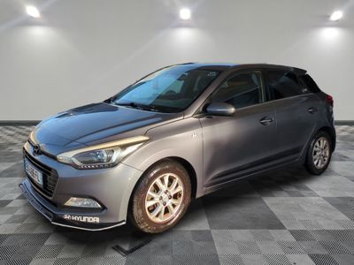 a grey car is parked in a room with a checkered floor