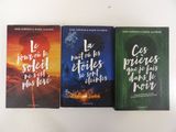 three books are sitting on a table with a white background