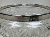 a glass bowl with a silver lid on a table