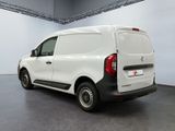 the back of a white van parked inside of a building
