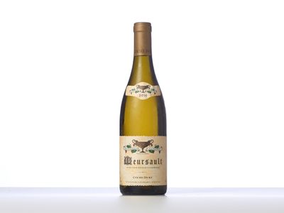 a bottle of white wine sitting on top of a table