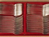 many spoons in a red box on the table
