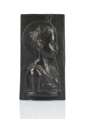 a black sculpture of a woman with a cross in her hand