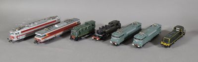 several toy trains are lined up next to each other on a table