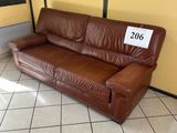 a brown leather couch with a price tag on it