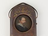 portrait of a man with a beard in a leather case