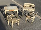three chairs and a table in the middle of the street