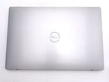 dell laptop computer sitting on a white surface with a dell logo on the screen