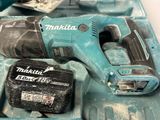 a cordless drill and a battery in a case