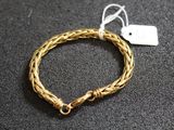 Gros plan sur un bracelet en or portant une étiquette