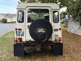 a white land rover parked on the side of the road