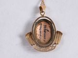 a gold necklace with a picture of a baseball player on it