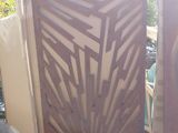 a couple of wooden gates sitting next to each other on top of a sidewalk