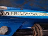 a close up of a sign on the side of a blue truck