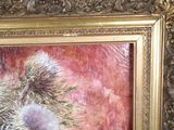 a picture of a painting of a flower in a gold frame