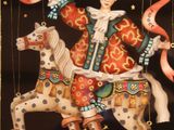 a painting of a man riding a horse with a banner on it
