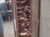 a close up of a mirror with carvings on it