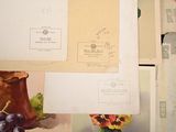 a bunch of papers and a vase on a table
