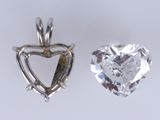 pair of heart shaped diamond pendants on a white background