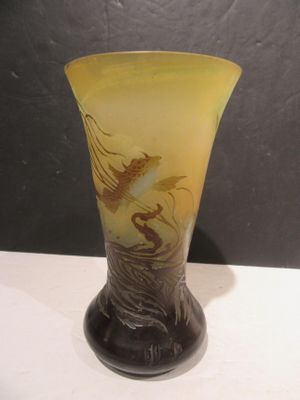 a glass vase with a dragon on it on a table