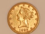 a close up of a gold coin with a woman ' s head on it
