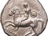 an old silver coin with a man riding a horse on it