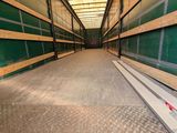 an image of a long hallway in a building with green walls