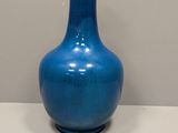 a blue vase that is sitting on a table