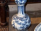 two vases sitting next to each other on the floor