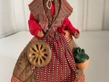 an image of a figurine of a woman with a basket of flowers