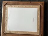 an old picture frame with a piece of paper in it