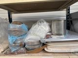 many plates and cups on the shelf in the kitchen